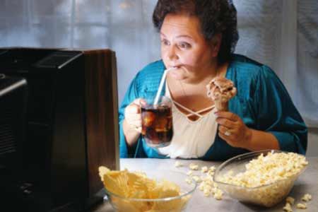 older-woman-eating-watching-tv