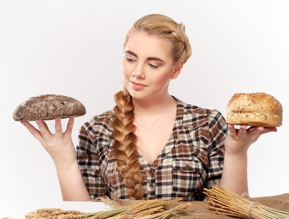 woman-choosing-between-rye-and-wheat-bread